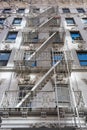 A White Fire Escape on the Side of an Old Beautiful White Building in New York City Royalty Free Stock Photo