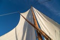 Looking up the wooden sail. Sailing in the sea on old wood sailboat. Summer adventure on a sunny day