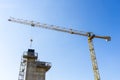 Looking up at a yellow crane dropping off material on a building under construction or work site Royalty Free Stock Photo