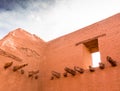 Looking upwards at adobe wall, window, and exposed beams of Spanish mission, Pecos National Historical Site, New Mexico