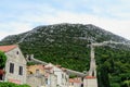 Looking upwards from the old croatian town of Ston at the ancient Walls of Ston in the forested mountains above beautiful Ston