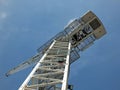 Upwards view of a large white tower construction crane against a blue sky Royalty Free Stock Photo