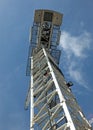 View of a large white tower construction crane against a blue sky with clouds Royalty Free Stock Photo