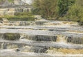 Looking upwards at waterfalls falling steeply from a bridge Royalty Free Stock Photo