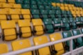 Blurred background. Looking visually impaired person. Yellow and green plastic seats in the stands of the sports complex. Royalty Free Stock Photo