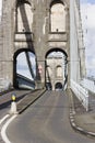 Looking westwards through the stone arches of the Menai Suspension Bridge, Gwynedd, North Wales