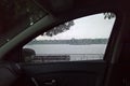 Looking through the wet car window at the river, on rainy day. Royalty Free Stock Photo