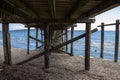 Looking through White Rock`s wooden pier to moored boats