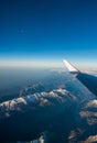 Looking through the window aircraft during flight a snow covered Italian and Osterreich Royalty Free Stock Photo