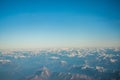 Looking through the window aircraft during flight a snow covered Italian and Osterreich Royalty Free Stock Photo