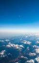 Looking through the window aircraft during flight a snow covered Italian and Osterreich Alps with blue sky without clouds Royalty Free Stock Photo