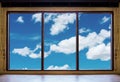 Looking through window, wooden window frames with blue sky and white clouds view Royalty Free Stock Photo