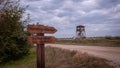 Lookout tower and wooden direction signs near a road in Axios Delta National Park in Northern Greece