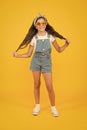 Looks best. cheerful little girl yellow background. retro child long hair. small girl vintage look sunglasses. happy