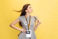 Half-length portrait of young girl, correspondent holding reporter microphone isolated on yellow studio background