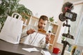 It looks delicious! Portrait of bearded food blogger holding a plate with fresh sandwich while recording new video