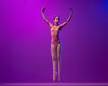 Studio shot of beautiful school age girl, ballet dancer dancing  on purple background in neon light. Art, grace Royalty Free Stock Photo