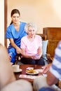 Looks like a close game. seniors playing cards in their retirement home. Royalty Free Stock Photo