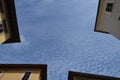 Four part of the houses with wonderful shapes of the clouds on the sky