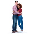 Looks like love. Studio portrait of happy young couple standing against a white background. Royalty Free Stock Photo