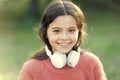 She looks like a music lover. Adorable little girl outdoor. Little girl child wearing headphones. Happy child enjoy Royalty Free Stock Photo