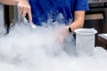 Worker making ice cream with liquid nitrogen