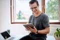 This looks like something groundbreaking. a young businessman using a digital tablet in an office.