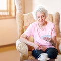 Looks like a winning hand to me. a happy senior woman looking at her cards during a game with her friends in a Royalty Free Stock Photo