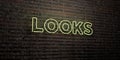 LOOKS -Realistic Neon Sign on Brick Wall background - 3D rendered royalty free stock image