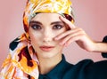 She looks right into your soul. Studio portrait of a confident young woman wearing a colorful head scarf while posing Royalty Free Stock Photo