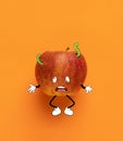 Contemporary artwork. Cute sad red apple thinking isolated over orange background. Drawn fruit in a cartoon style Royalty Free Stock Photo