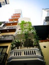 Lookup view complex high-rise apartment buildings blocks steel cage vining plants, downtown Hanoi popular tiger cages or bird nest Royalty Free Stock Photo