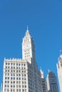 Lookup view of typical skyline building with rooftop tower clock in Chicago downtown