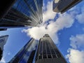 Lookup view of variety of coporate business high-rise skyscrapers buildings with blue bright sky in central business distric Royalty Free Stock Photo