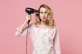 Loony woman housewife in casual clothes, apron posing isolated on pastel pink background. Housekeeping concept. Mock up Royalty Free Stock Photo