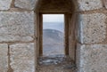 The loophole on the corner tower in the medieval fortress Ash Shubak, standing on a hill near Al Jaya city in Jordan Royalty Free Stock Photo