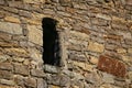 Loophole of a medieval watchtower in sunlight