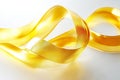 looping liquid ribbon in gold, gently flowing and intertwining, creating an elegant and soothing