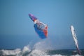 Looping windsurfer against blue sky using Fanatic windsurf board and Simmer Style Sail El Medano, Tenerife, Spain Royalty Free Stock Photo