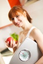 Loosing weight - woman with scale and apple Royalty Free Stock Photo