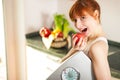 Loosing weight - woman with scale and apple Royalty Free Stock Photo