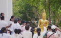 LOPBURI, THAILAND - 18 MAY 2019 - Thai Buddhist hold big Buddha statue and the fired candle in hand