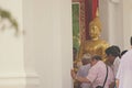 LOPBURI, THAILAND - 18 MAY 2019 - Thai Buddhist hold big Buddha statue and the fired candle in hand