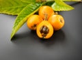 Loquat fruit or Japanese medlars, Nispero, Eriobotrya japonica with leaves fresh ripe bio vegetarian food