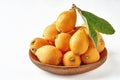 Loquat fruit. Nispero. Eriobotrya Japonica. Loquat in bowl with fresh leaves. Close up