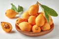 Loquat fruit. Nispero. Eriobotrya Japonica. Loquat in bowl with fresh leaves. Close up