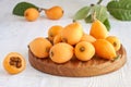 Loquat Medlar fruit with leaves on wood background Royalty Free Stock Photo