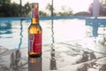 Loraine beer, Packshot of bottle of beer with blurred swimming pool in background Royalty Free Stock Photo