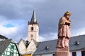 Lorch, Germany - 03 14 2022: medieval bishop statue and the church of Lorch am Rhein Royalty Free Stock Photo