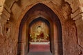 Lord Buddha sculpture sitting in meditation inside ancient temple in Bagan, Myanmar.